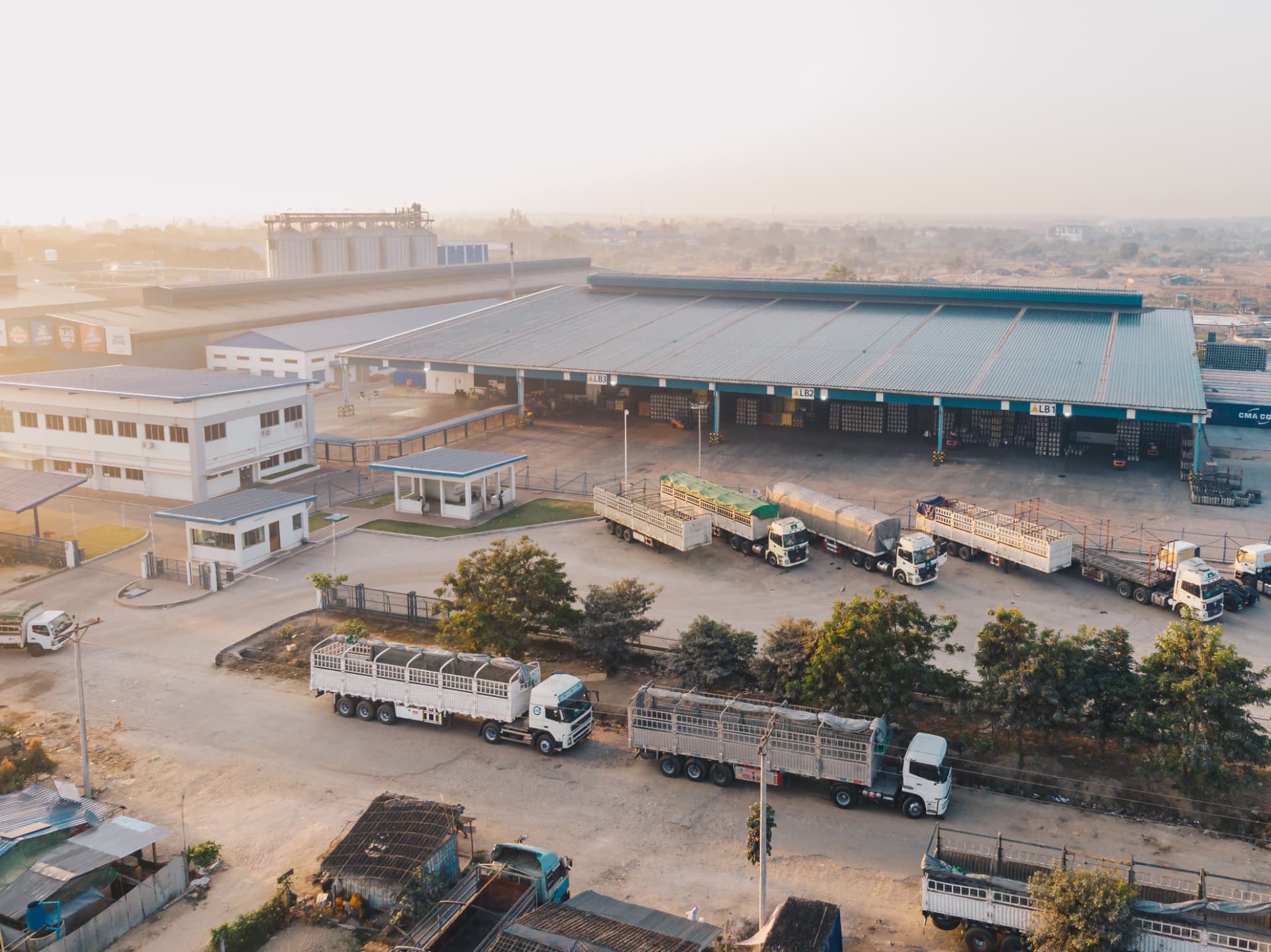 Aerial view of a logistics facility with trucks parked in a yard
